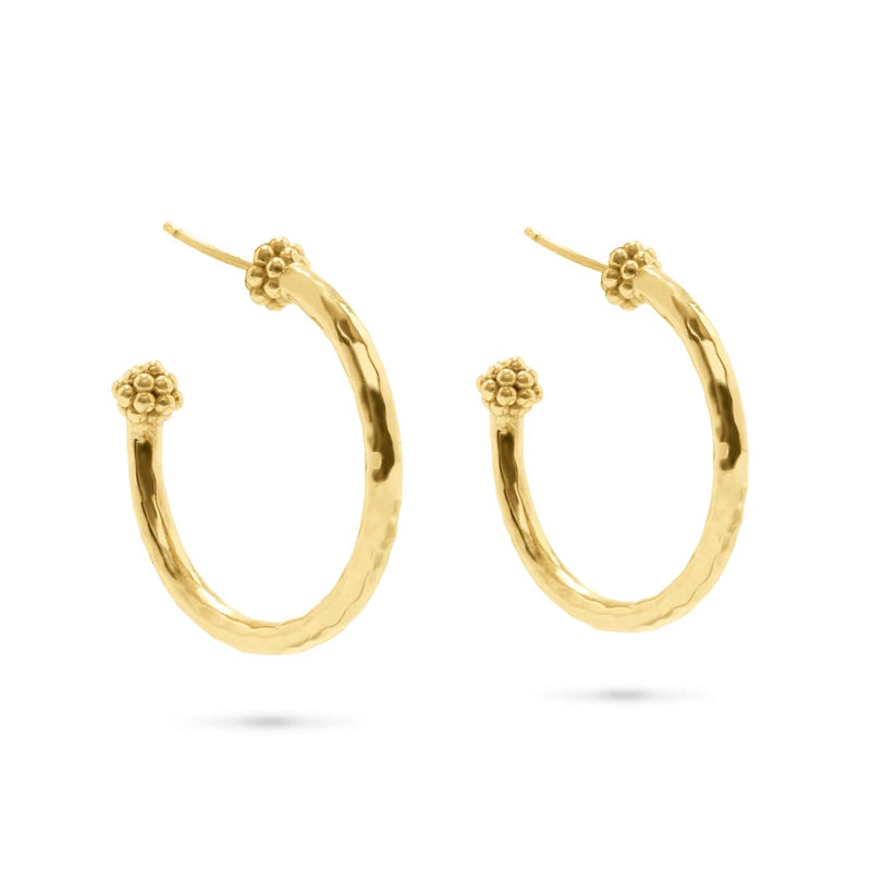 The quintessential gold hoop, wrought in hammered gold and finished with a berry, is anything but ordinary.