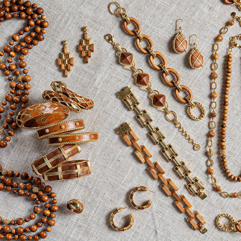 Teak and gold jewelry on a white background.