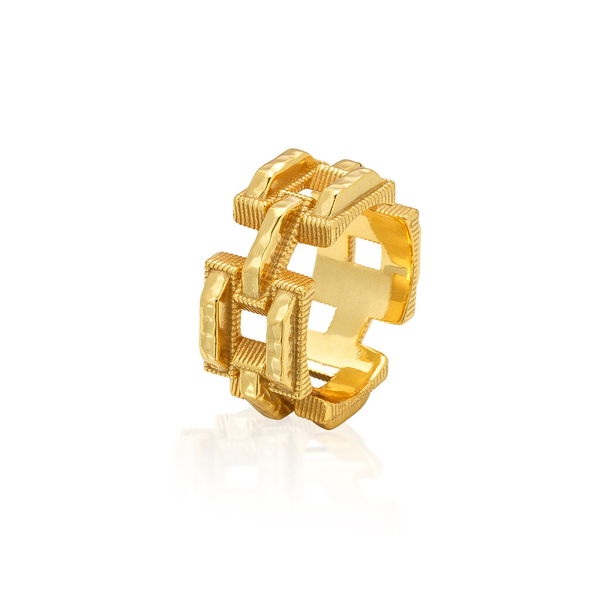 A gold geometric ring with a textured, interlocking openwork design, shown on a clean white background with a soft reflection.