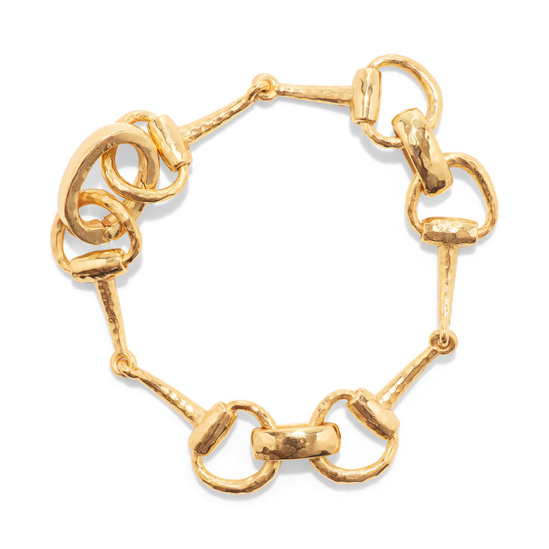 For those who love the majesty of horses, we’ve reinterpreted a classic chain bracelet in equestrian form, featuring interlinking snaffle bits. The first bit introduced to a yearling, the snaffle bit symbolizes gentleness and communication while its radiant gold finish is a reminder that sometimes you have to just jump the fences and blaze your own trail. Timeless, sculptural and chic, this bracelet delivers the perfect dose of glamor and gumption to your favorite pair of jeans or cocktail dress.
