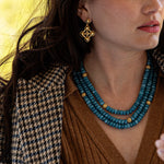 We love to live colorfully. Our triple strand necklace with richly saturated hues of jewel-toned jade beads, strung and polished like pearls and dotted with a sprinkling of golden berries. Simultaneously decadent yet earthy, this bewitching statement piece sings with any outfit, for any occasion. Offered in Ocean Blue, African Violet and Meadow Green.