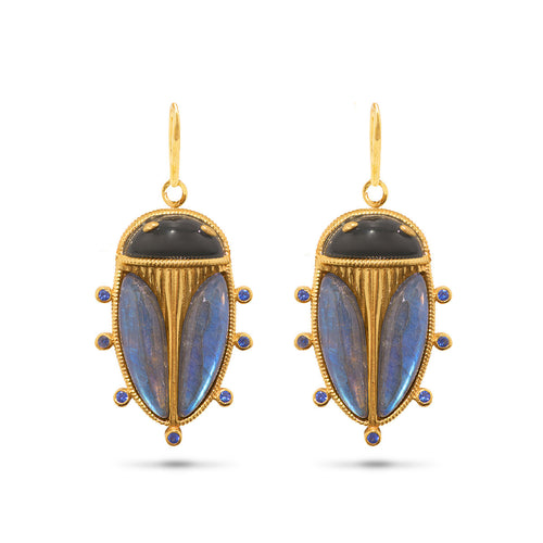 This intricate little pair of scarabs dangle from golden rope hoops and are rendered in luminescent blue labradorite with black onyx. Wear them as asn empowering talisman of resilience for starting fresh every day.