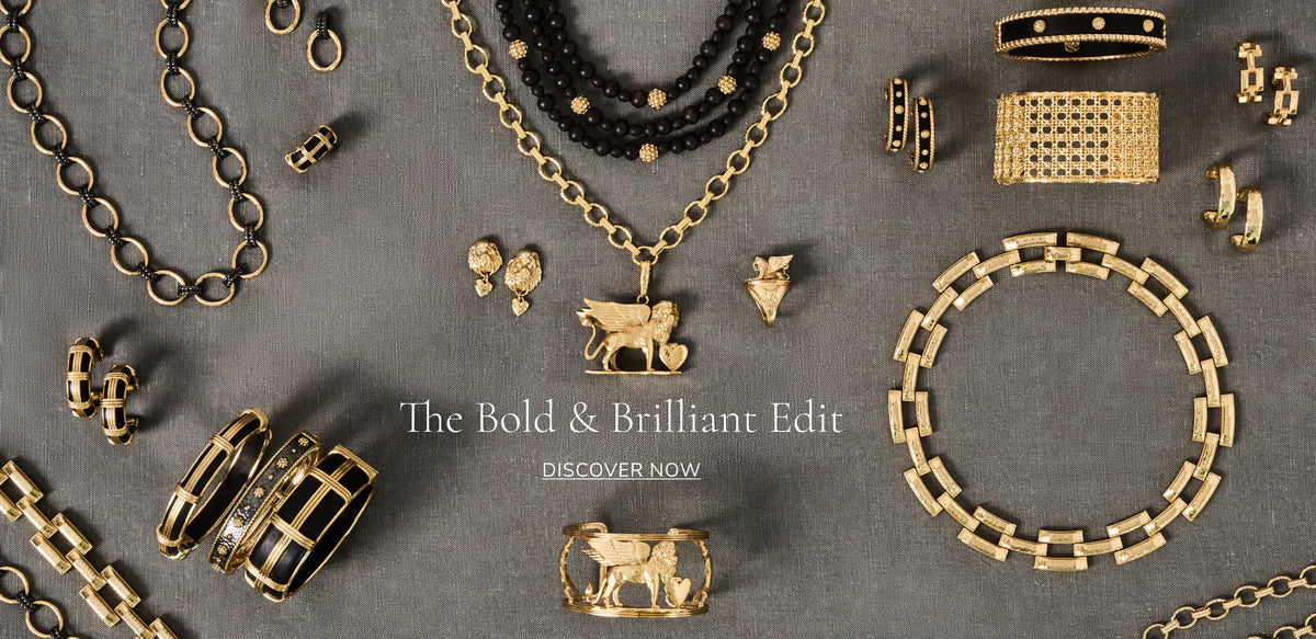 An editorial flat-lay of gold jewelry pieces including necklaces, bracelets, rings, and earrings, arranged on a textured gray background with the text 'The Bold & Brilliant Edit' in the center.