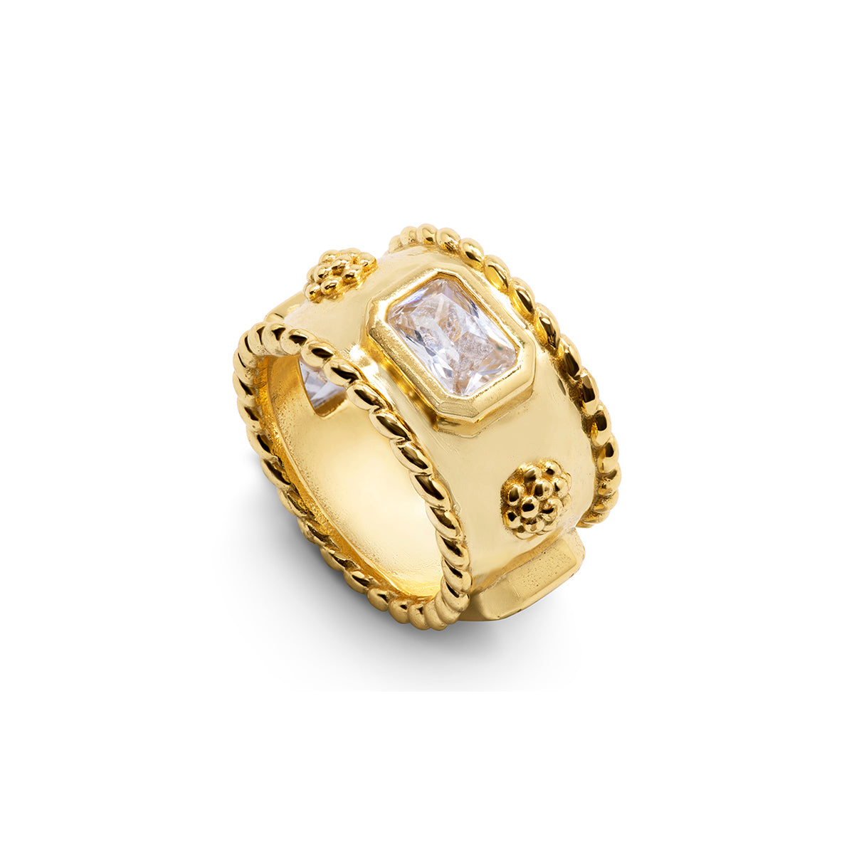 A wide gold ring featuring a central rectangular clear gemstone, textured floral details, and a twisted rope border, shown on a plain white background.