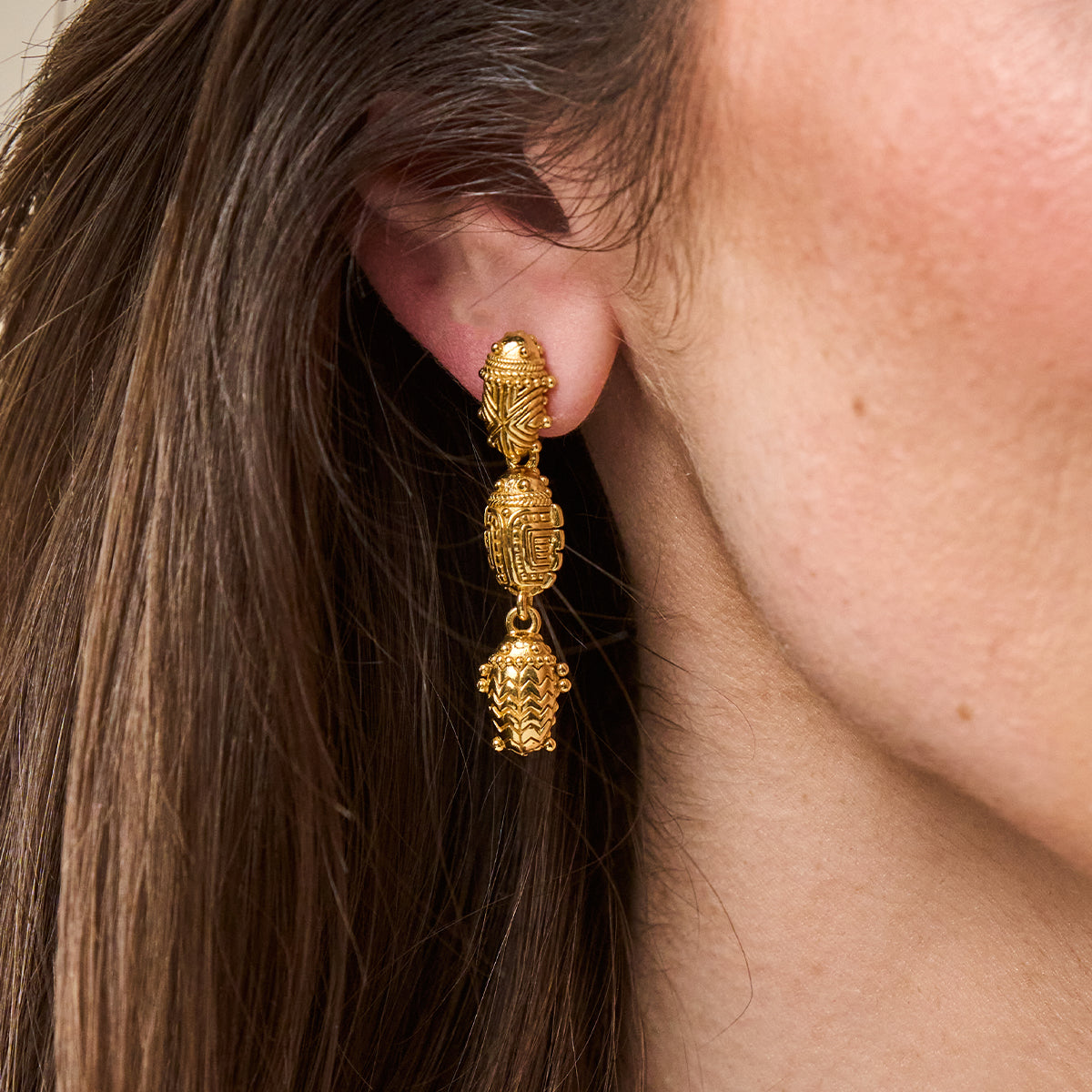 Scarab Petite Linear Earrings - Gold close up of earrings on ear