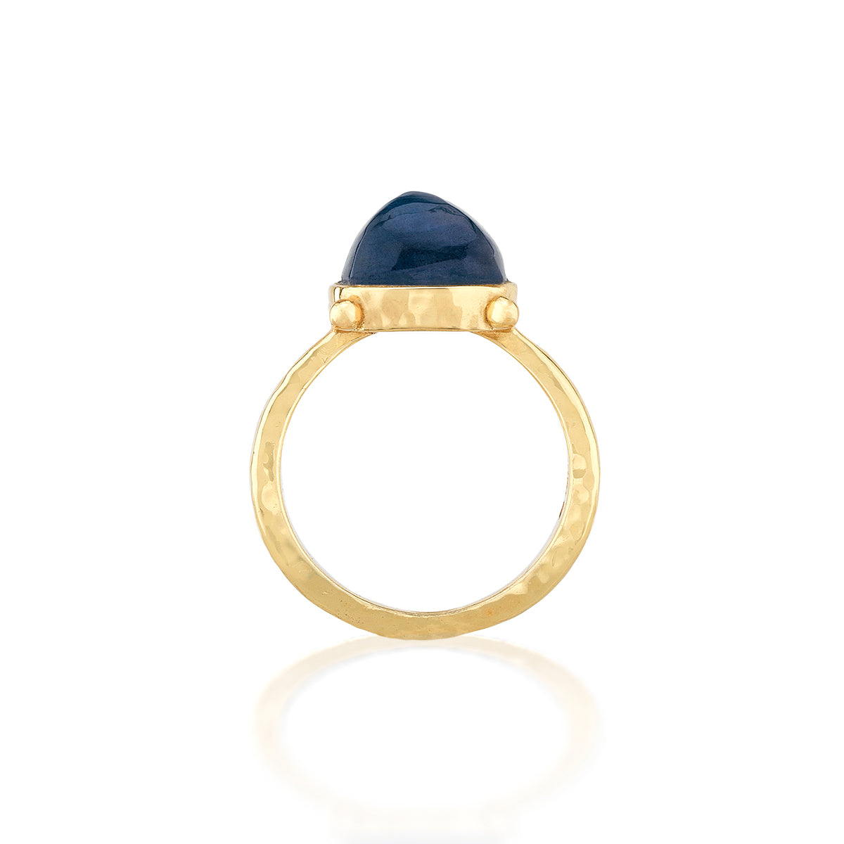A gold ring with a hammered finish and a small, rounded dark blue cabochon gemstone, shown on a clean white background with a soft reflection below.