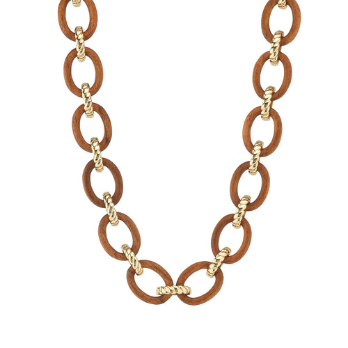 We’ve reimagined the classic link necklace as if it were to be designed by Mother Nature herself, with hand-carved links of polished teak wood bound with gleaming, golden ropes. This understated and earthy statement necklace pairs with cowgirl boots and jeans just as beautifully as it does a cocktail dress and heels and is a reminder to drink in the fresh air and stay grounded.
