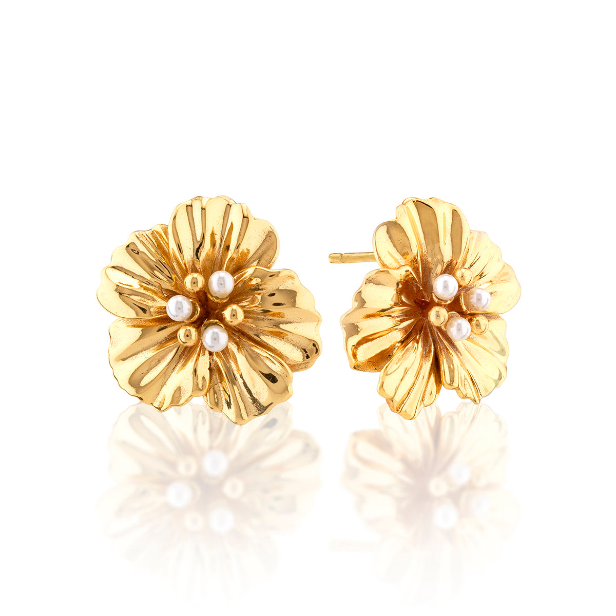 These statement earrings are abloom with golden garden splendor, romantic ruffled petals, and a sprinkling of tiny pearls for an effect that brings a glamorous dose of feminine flower power to whatever you pair them with, day or night.