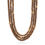 Simplicity at its finest, inspired by Mother Nature's quiet beauty, this single strand of gorgeous hand-carved teak beads accented with two golden berries is a masterclass in uncontrived elegance. Dress up a basic t-shirt while still feeling understated or add to a bohemian summer dress for a bit or earthy opulence. This go-to piece also delivers a lovely textural and grounding element when layering with necklace chains.