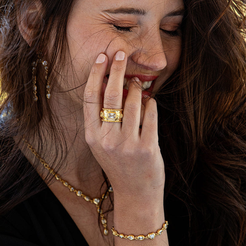On its own or in a ring stack, this classic band sings in shimmering hammered gold and is a harmony of our iconic berry and thread motif and crystal clear embellishments to sparkle and shine alongside your own inner light.