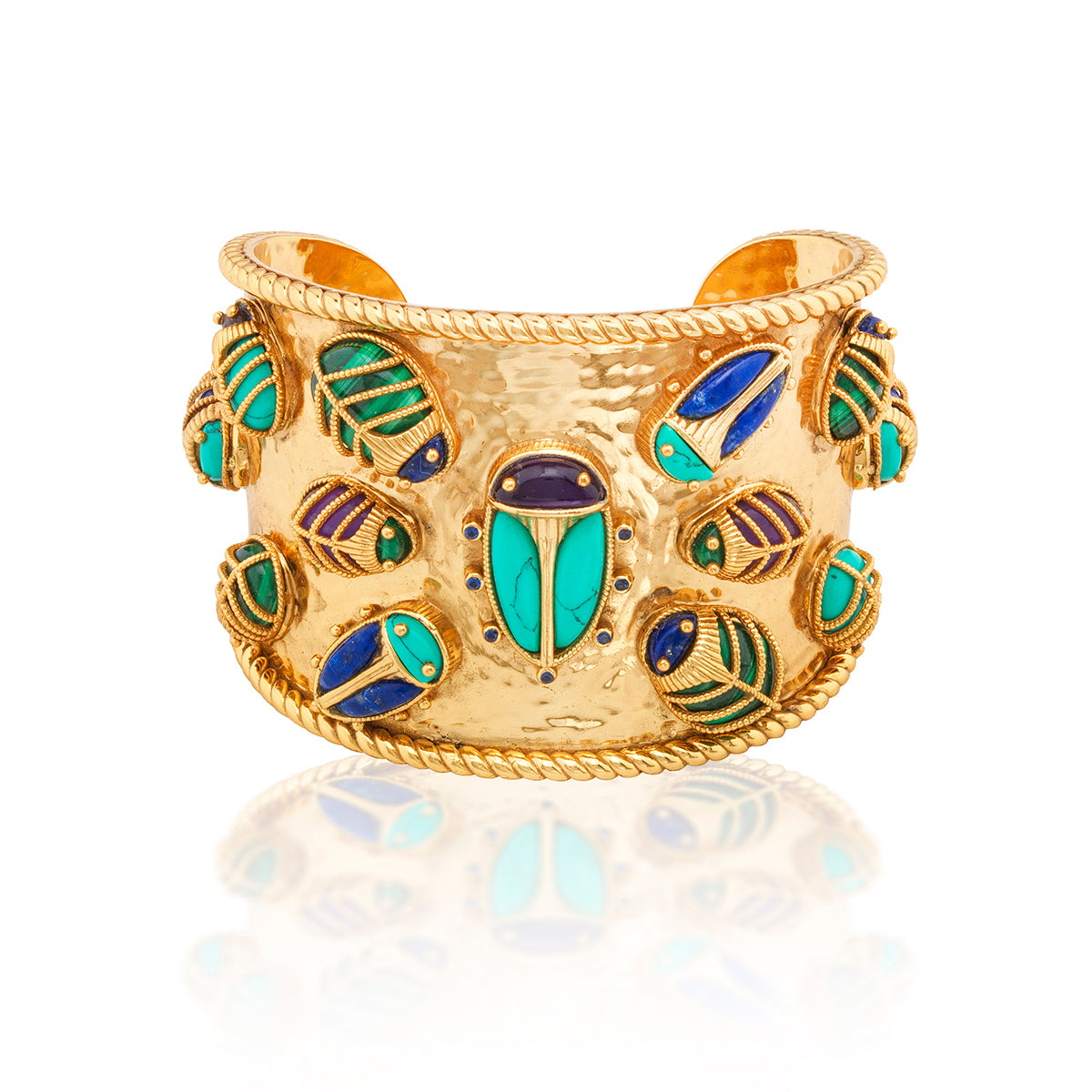 Regal and radiant, this bold statement cuff is wrought in bright hammered gold for a shimmering effect and trimmed with a twisting thread. Like the queen of the Nile, a grande scarab is at the center, with her polished turquoise wings and a luminous amethyst head, surrounded by her vibrant offspring. Just like all families, each charming creature is similar and unique, with intricate gilded exoskeletons and vibrant hand-carved wings and heads in a riot of colorful amethyst, lapis, malachite and turquoise.