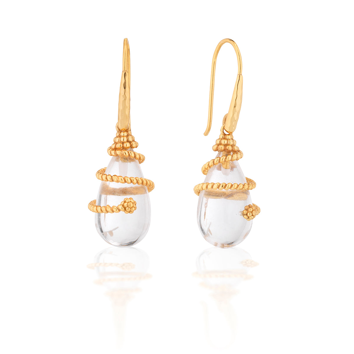Gold earrings with clear teardrop-shaped stones on a white background