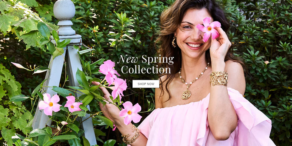 Woman playing with flowers wearing Meadow Walk jewelry from Capucine De Wulf collection