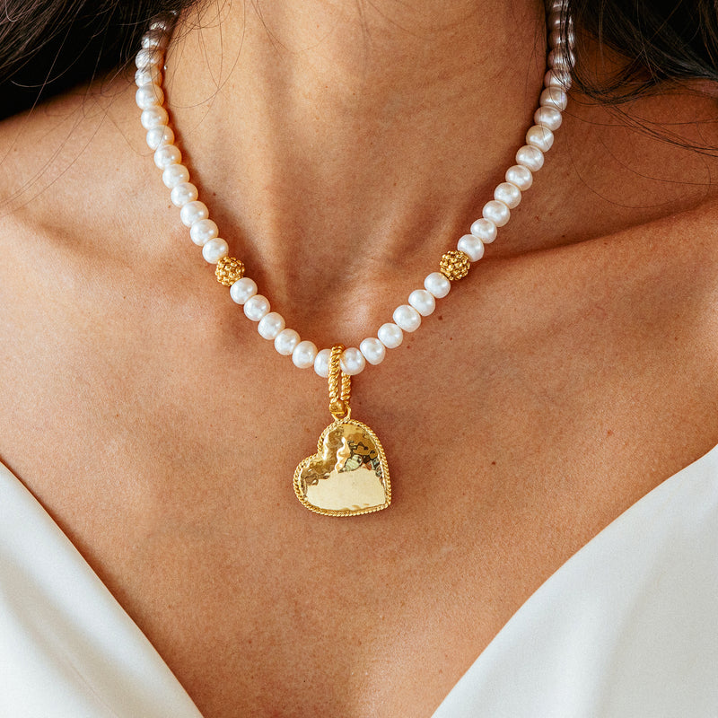 Capucine De Wulf heart pendant necklace on a pearl necklace