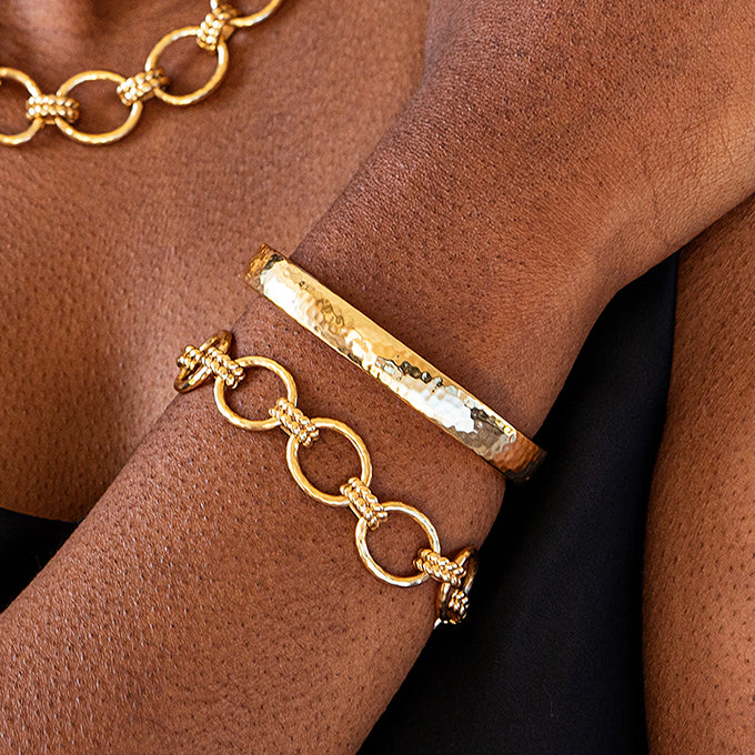 Gold bracelets on a wrist