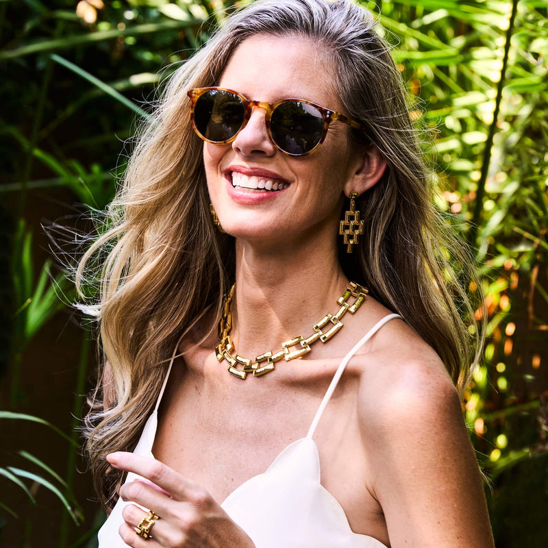 Woman in sunglasses wearing Pathway jewelry from Capucine De Wulf