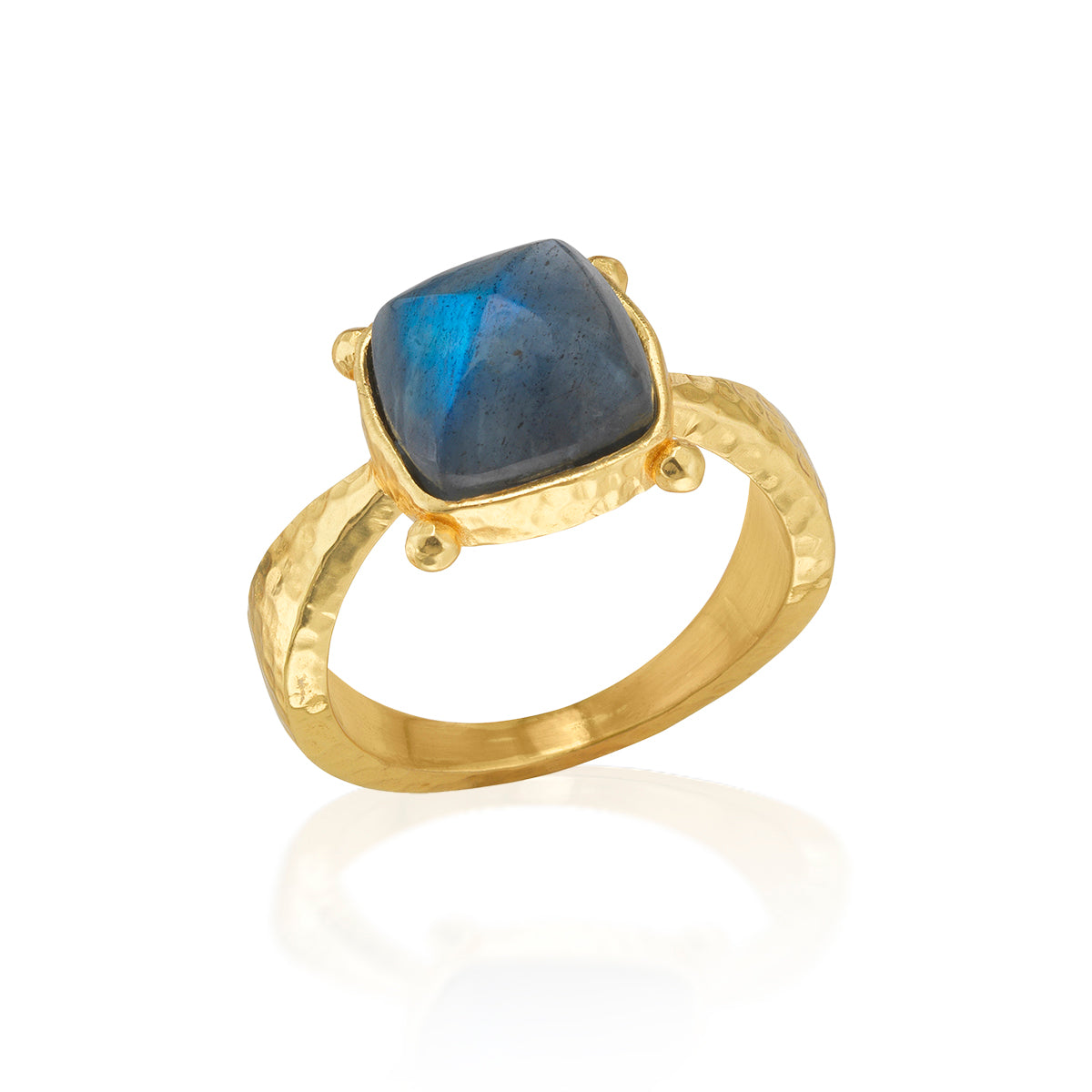 Gold ring with a blue gemstone on a white background