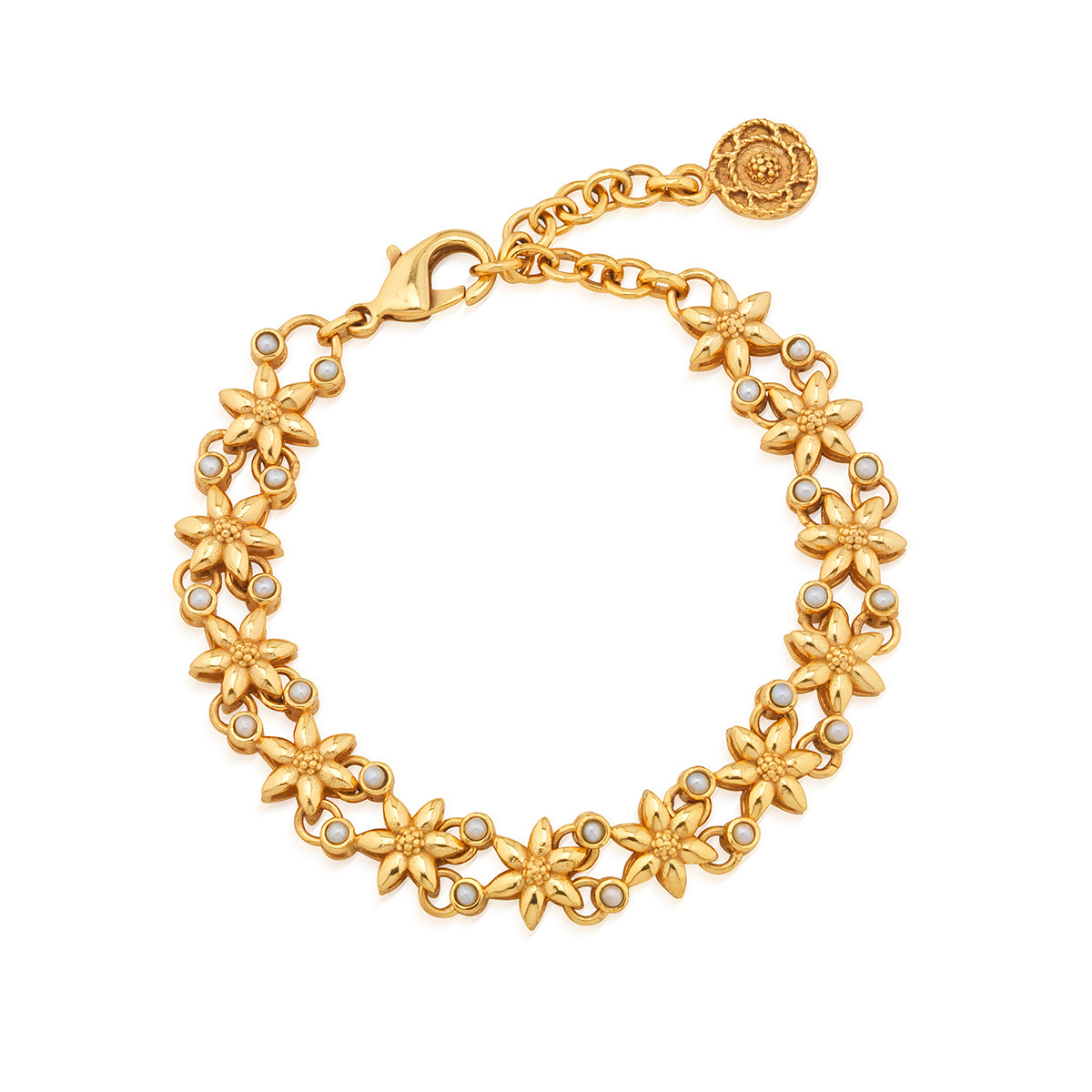 Tiny golden jasmine blossoms are interspersed with luminous white pearls to create this intricate and airy bracelet that elevates anything you pair it with—from jeans and a tee to party frocks for special occasions. The subtle splendor of this timeless bangle shines on its own or creates a lovely layer in a bracelet stack.