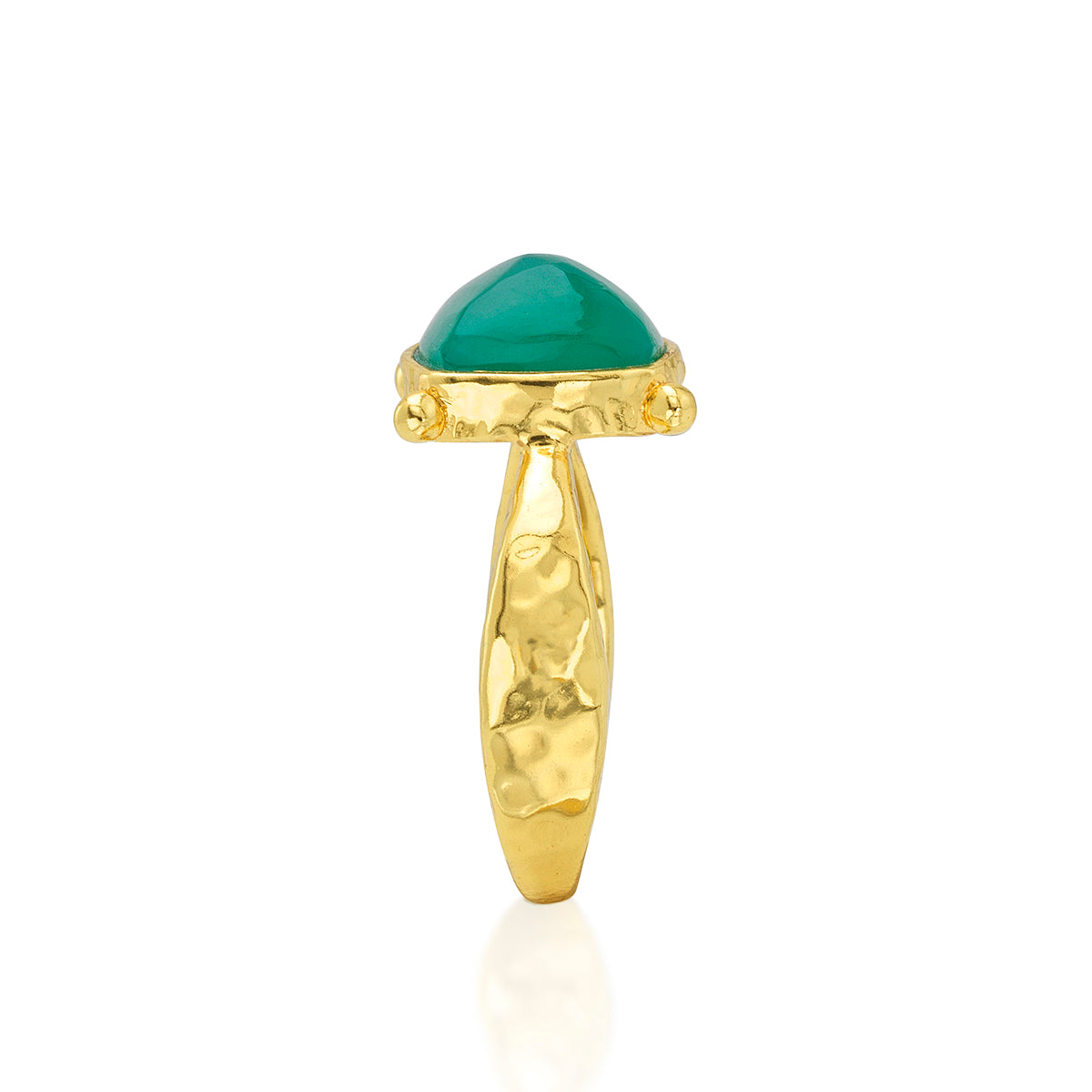 A gold ring featuring a smooth, dome-shaped green gemstone in a textured gold setting, shown against a plain white background with a soft reflection below.