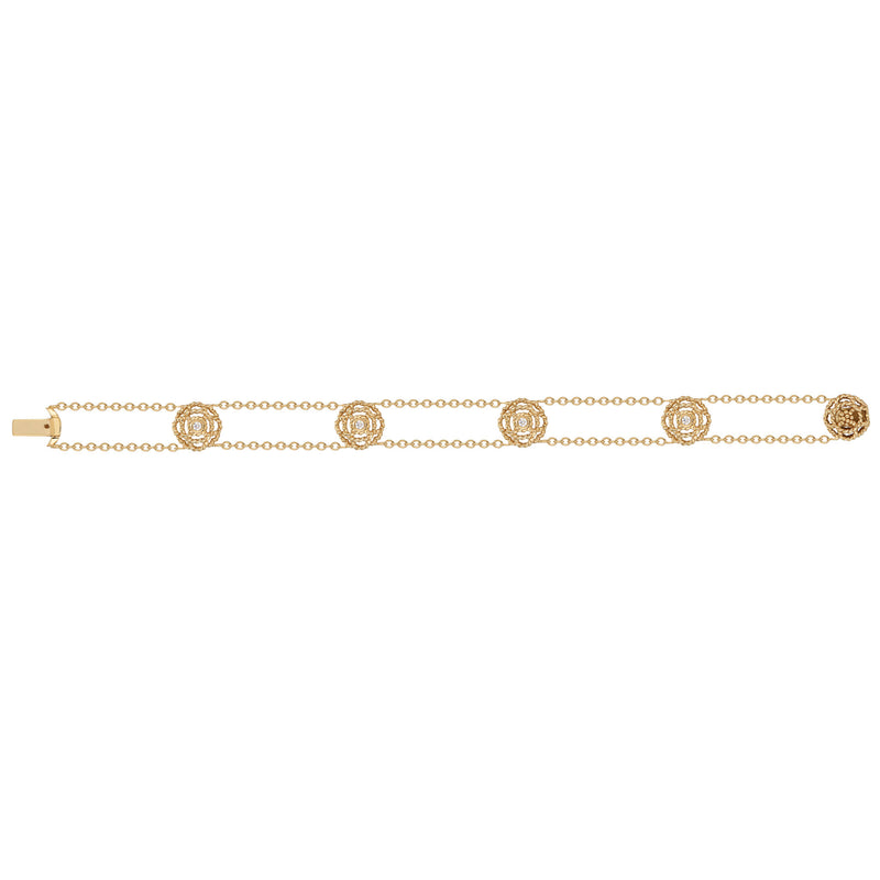 Our iconic blossom, a symbol for spreading Love, graces this petite bracelet which features four sparkling diamonds set in 18K gold. 