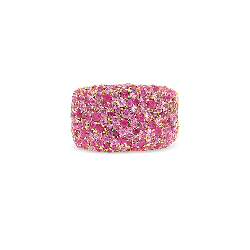 The glorious rubies and pink sapphires in this decadent ring glisten like over-flowing treasure. An updated classic with variegated stones sizes tightly nested in pirate sized chunk of gold.