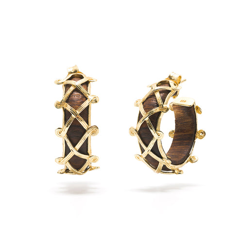 Hand carved Teak adorned with golden bands, these hoop earrings frame your face with glinting gold and rich dark wood. From our Earth Goddess collection, as you catch your reflection while wearing these statement earrings, you are a reminder to drink in the fresh air and stay grounded.