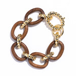From our Earth Goddess collection, this link bracelet encircles your wrist with links of hand carved links of polished Teak wood bound with gold ropes. As you wear this statement bracelet, be reminded to drink in the fresh air and stay grounded.