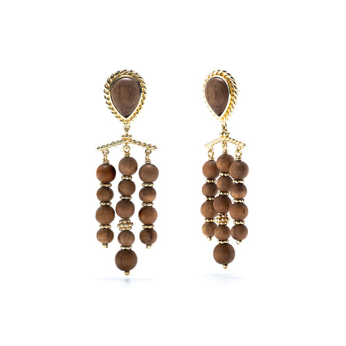 Hand carved Teak adorned with gold, these chandelier earrings frame your face with glinting gold and rich dark wood. From our Earth Goddess collection, as you catch your reflection while wearing these statement earrings, you are a reminder to drink in the fresh air and stay grounded.